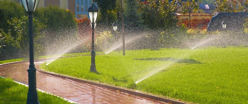 An irrigation system in Saddle River, NJ, with multiple sprinklers by lamp posts.