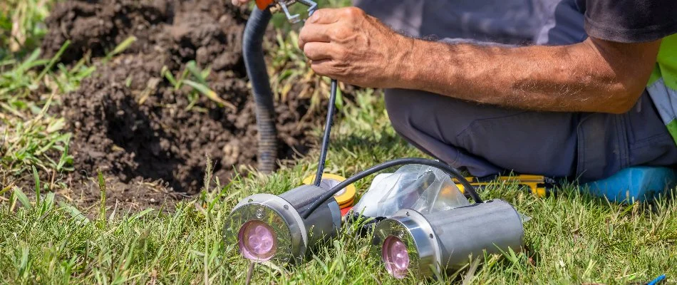 Professional doing repair work on an outdoor lighting fixture in Tarrytown, NY.