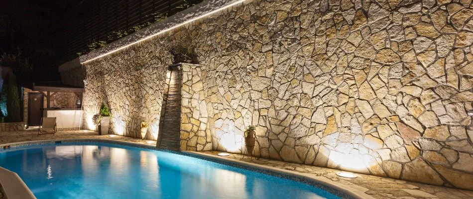 Wall-washing on an accent wall by a pool in Tarrytown, NY.