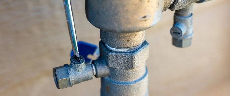 Adjusting the valve of an irrigation system in Hamden, CT.