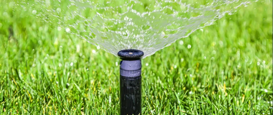 Irrigation system spraying water on a lawn in Manhattan, NY.