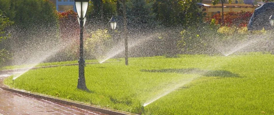 Lawn in New Rochelle, NY, with sprinkler irrigation and lamp posts.