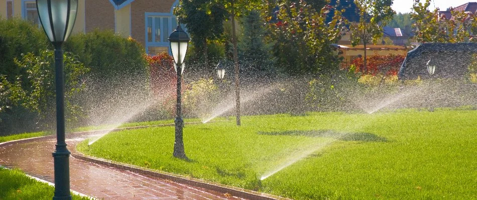 Lawn in Haverstraw, NY, with irrigation sprinklers and lamp posts.