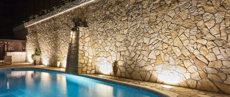 Outdoor lighting on a wall in White Plains, NY, next to a pool.