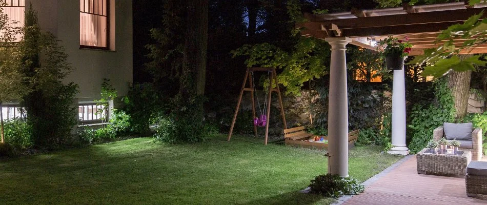 Pergola and garden in Stamford, CT, with outdoor lighting.