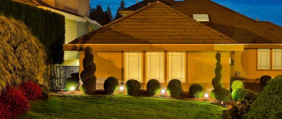 Yard in Ramapo, NY, with manicured shrubs and outdoor lighting.